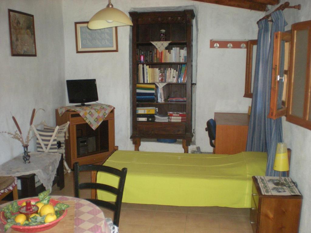 Petalidi Gedigio في بيتاليدهيون: غرفة معيشة مع سرير أخضر وطاولة