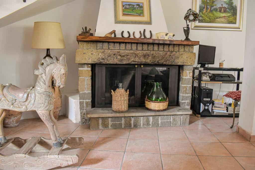 a fireplace with a rocking horse in a living room at Affittacamere D'amore in Foria