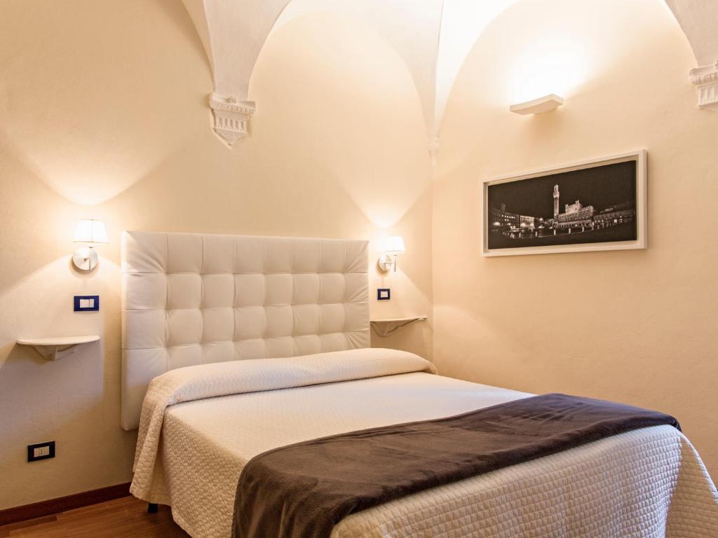 Llit o llits en una habitació de B&B Quattro Cantoni