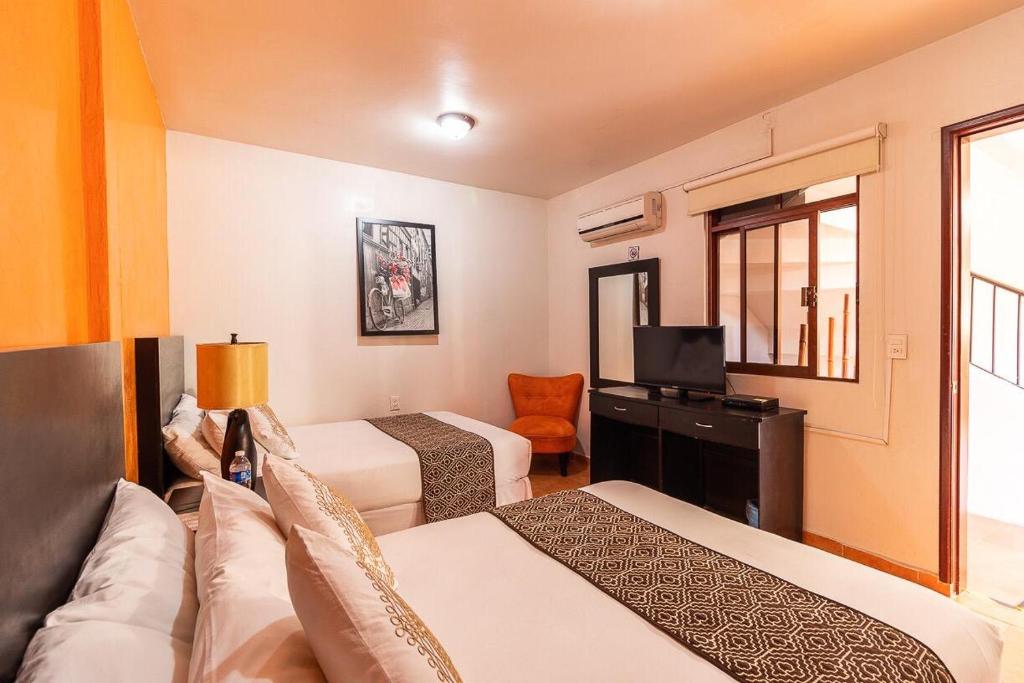 Postel nebo postele na pokoji v ubytování Hotel Doña Juana