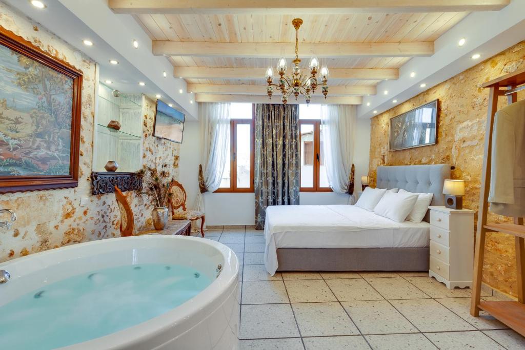 ハニア・タウンにあるHamam Suites Portouのバスルーム(バスタブ付)、ベッド1台が備わります。