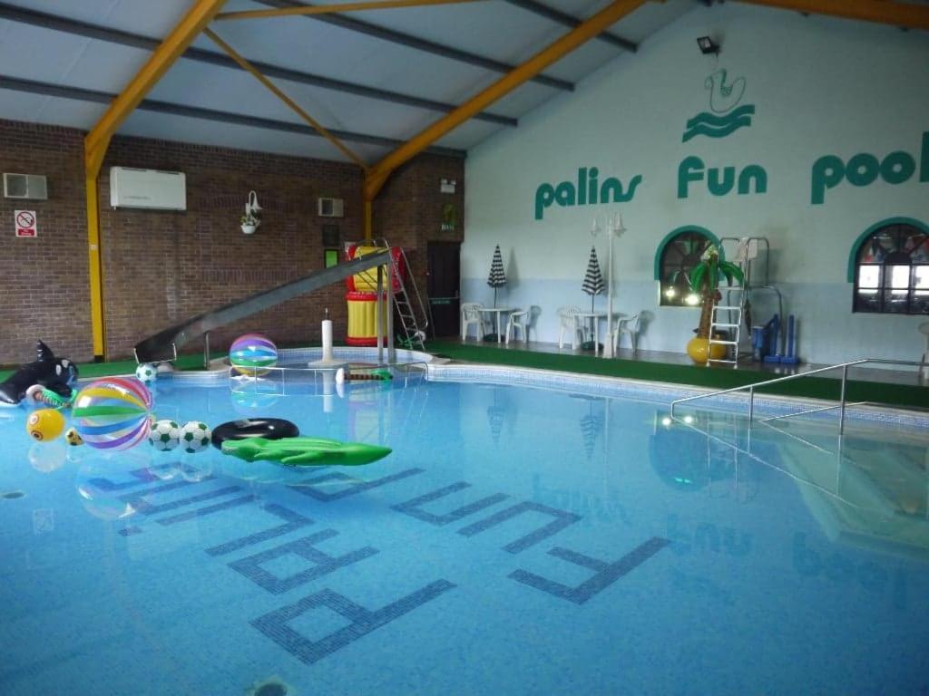 a swimming pool with balls and toys on the floor at Private Caravan on Palins Holiday Park, North Wales in Foryd