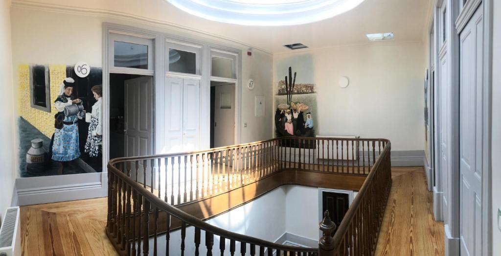 a hallway with a spiral staircase in a house at NorteSoul Mouzinho in Porto