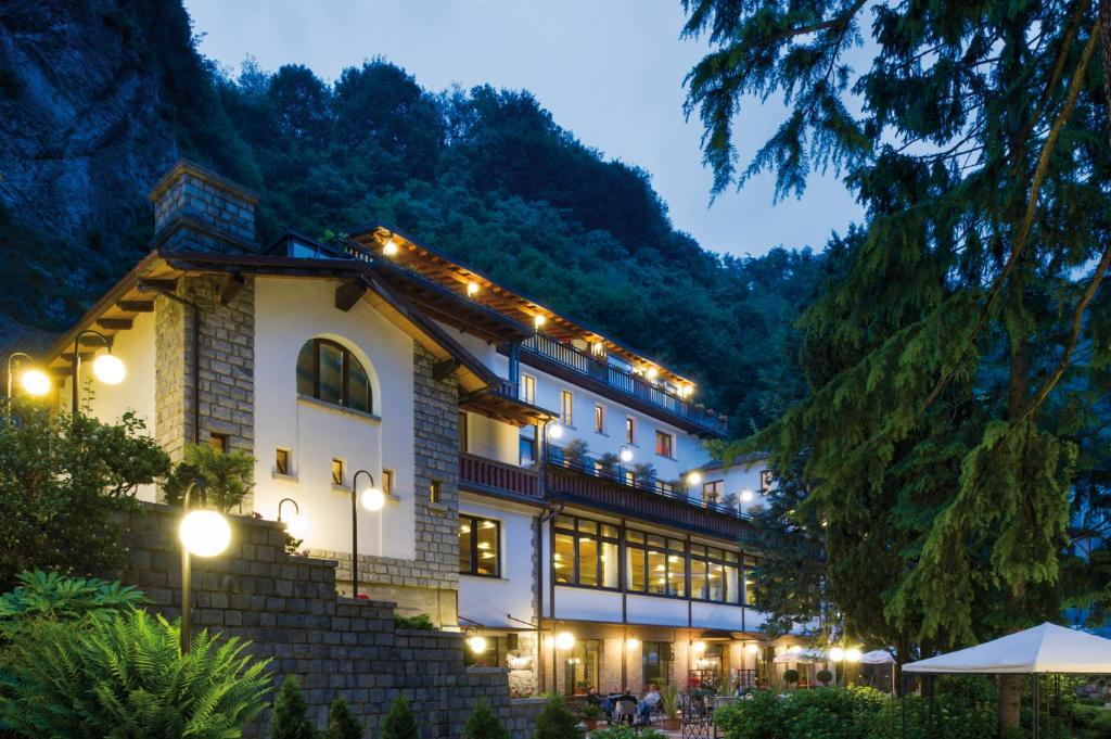 a building with lights on it at night at Hotel Oasi Verde in Bienno