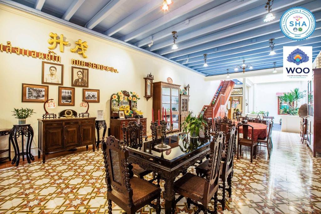 a room with a table and chairs in a room at WOO Gallery & Boutique hotel in Phuket