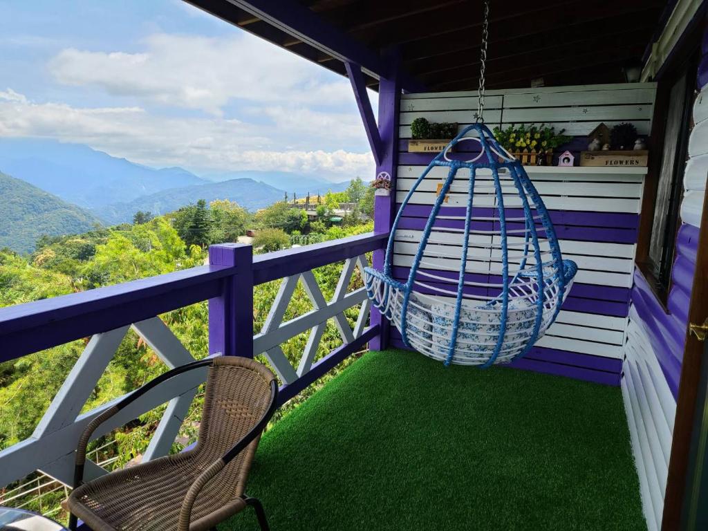 a porch with a chair and a swing at Julie&#39;s Garden, Cingjing - Fon Chin Homestay in Ren&#39;ai