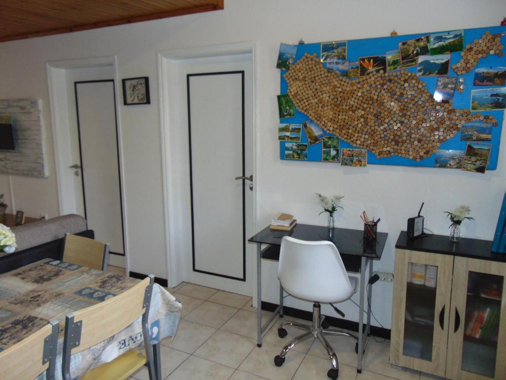 a room with a desk and a table with a chair at Marques House in Machico