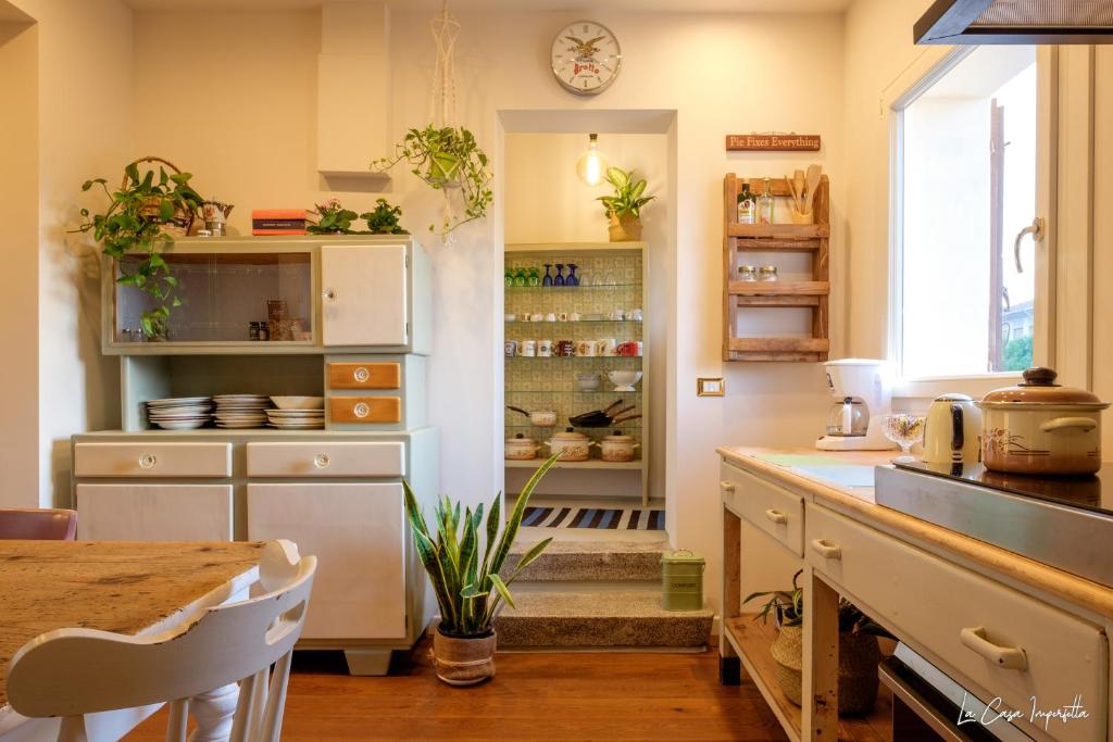 a kitchen with a counter and a table in it at La Casa Imperfetta in Treviso