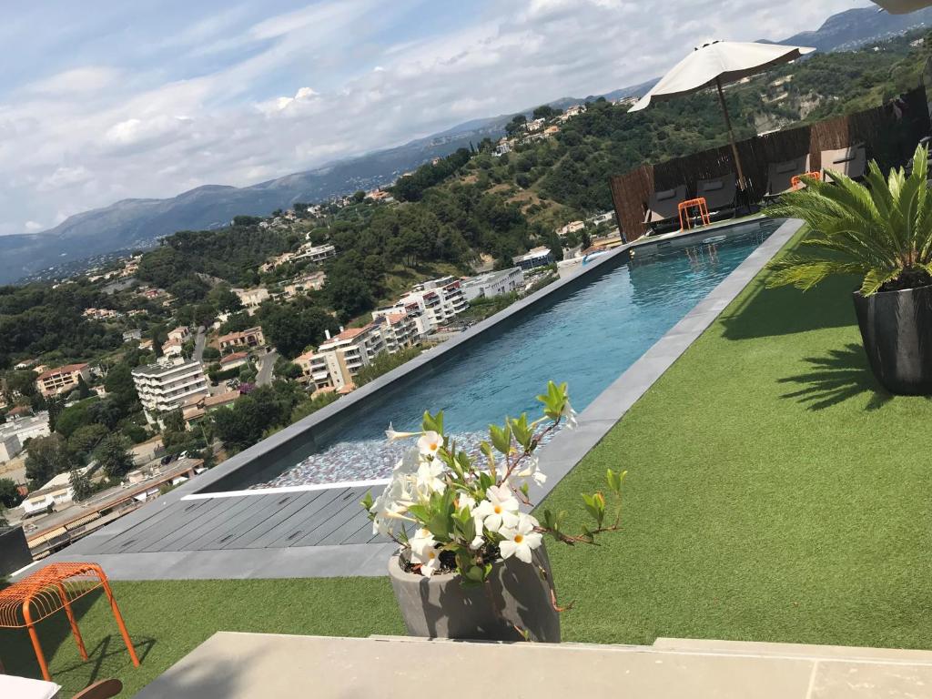 a swimming pool with a view of a city at Twenty Rent in Cagnes-sur-Mer