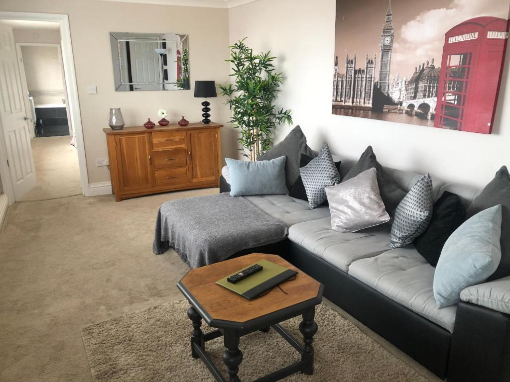 a living room with a couch and a coffee table at Sea view apartment in Cleethorpes