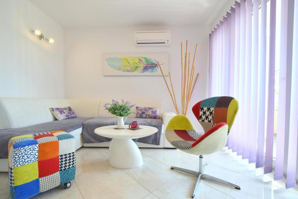a living room with a couch and a table and chairs at Apartment Acija in Malinska
