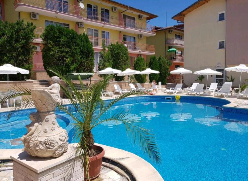 a swimming pool in front of a hotel at Курортно студио in Sunny Beach