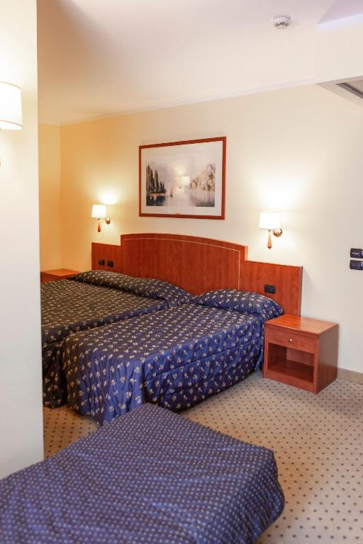 Postel nebo postele na pokoji v ubytování Hotel Olivo