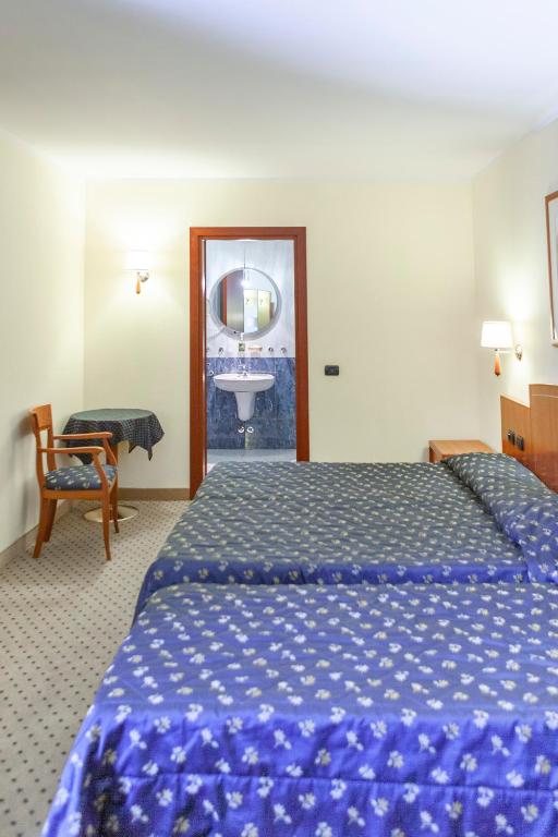 Postel nebo postele na pokoji v ubytování Hotel Olivo