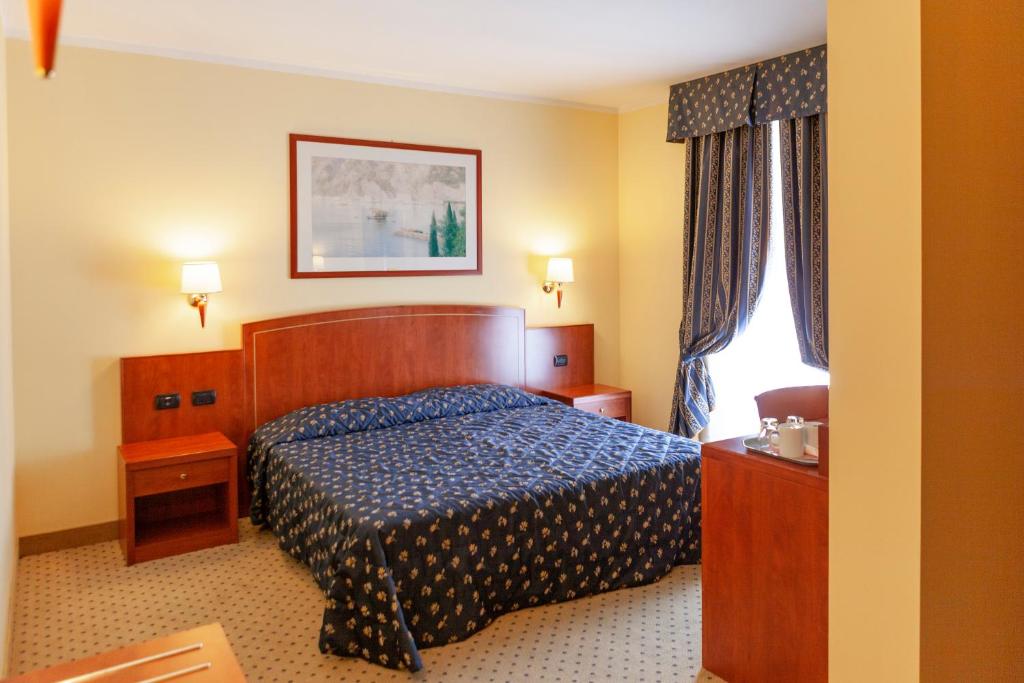 Postel nebo postele na pokoji v ubytování Hotel Olivo