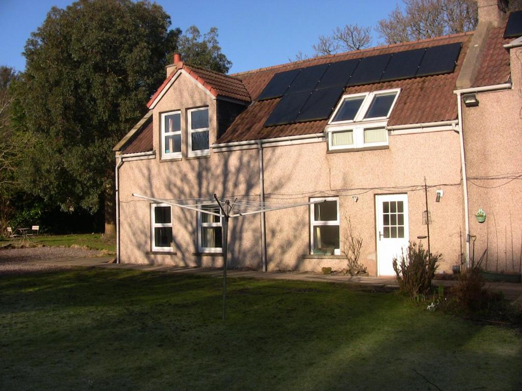 a house with solar panels on the roof at The Studio Pod, St Andrews in St. Andrews