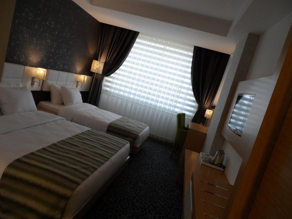 Postel nebo postele na pokoji v ubytování Inci Class Hotel