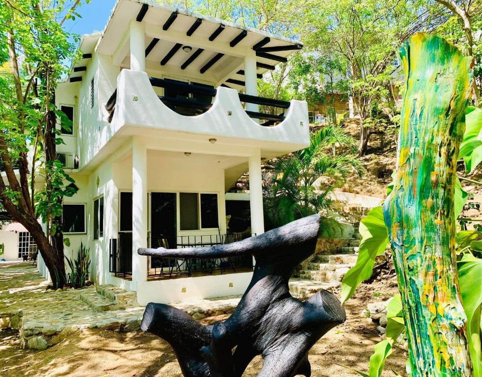 una casa con una statua davanti di Casa Il Tucano a Puerto Ángel