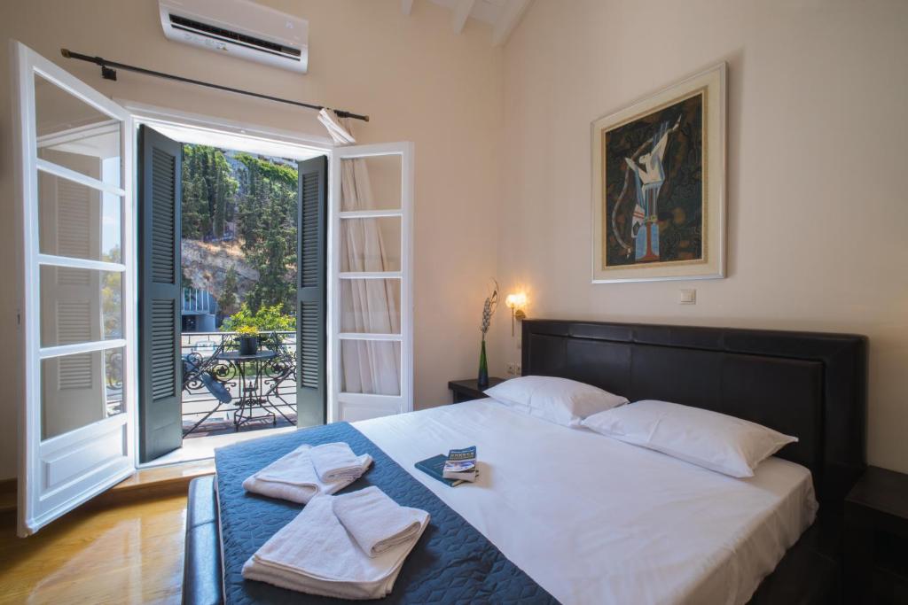 a bedroom with a large bed with towels on it at Pension Nikolaos in Nafplio