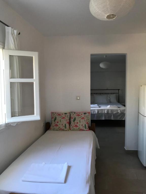 Postel nebo postele na pokoji v ubytování Vegera Apartment 'Ostria', Stavros Donoussa