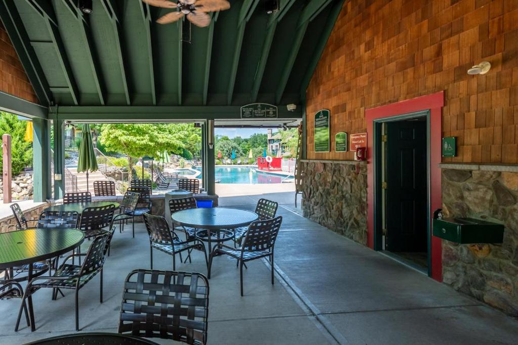 a patio with tables and chairs and a pool at Hawk Hill in Vernon Township