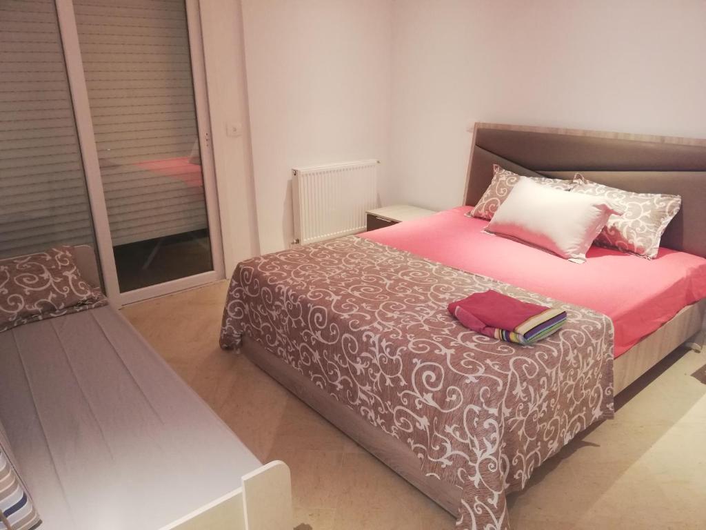 a bedroom with a bed with a book on it at Costa Marina 212 in Hammamet