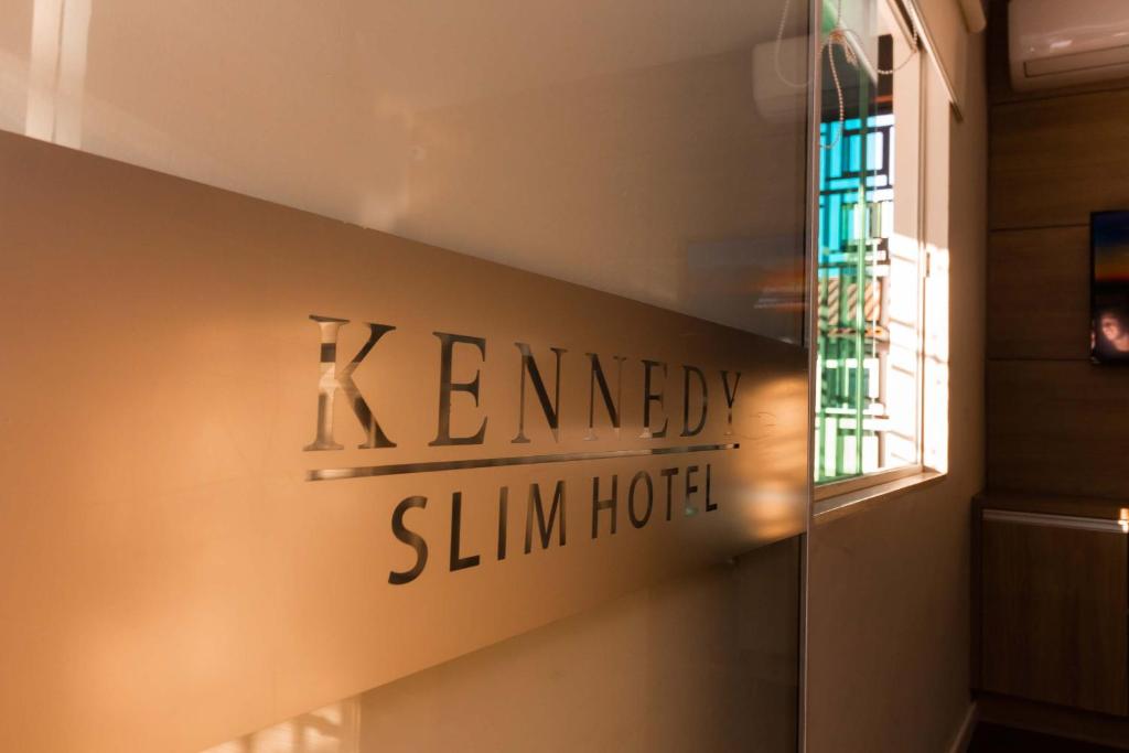 a sign on a wall that reads kennedy simm hotel at Kennedy Slim Hotel in São José