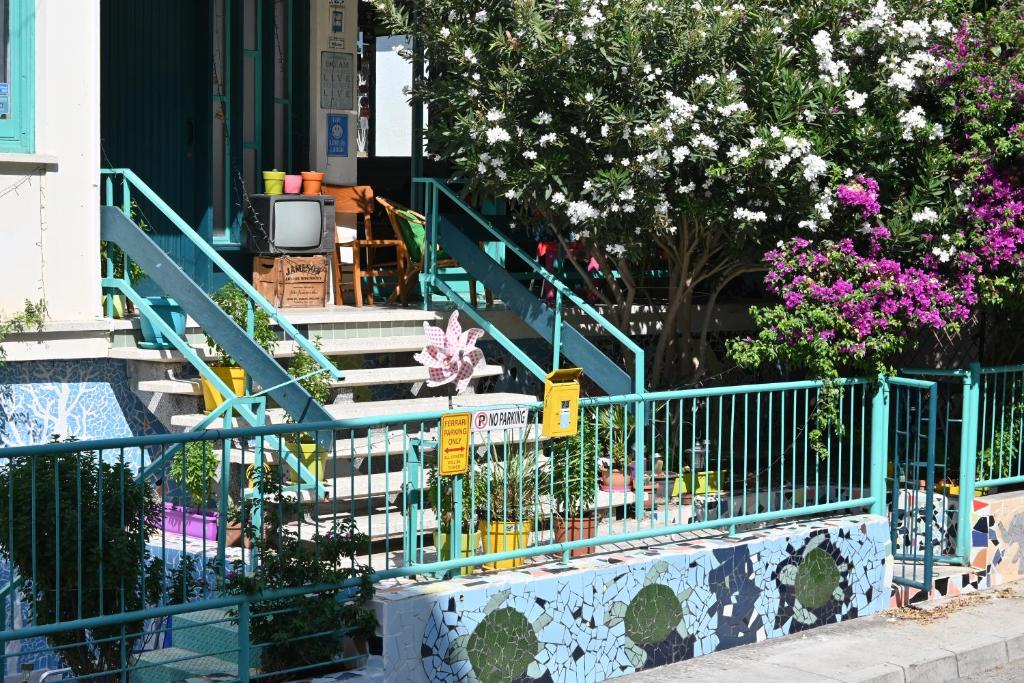 a set of stairs in front of a building with flowers at Lemongrass Hostel in Limassol