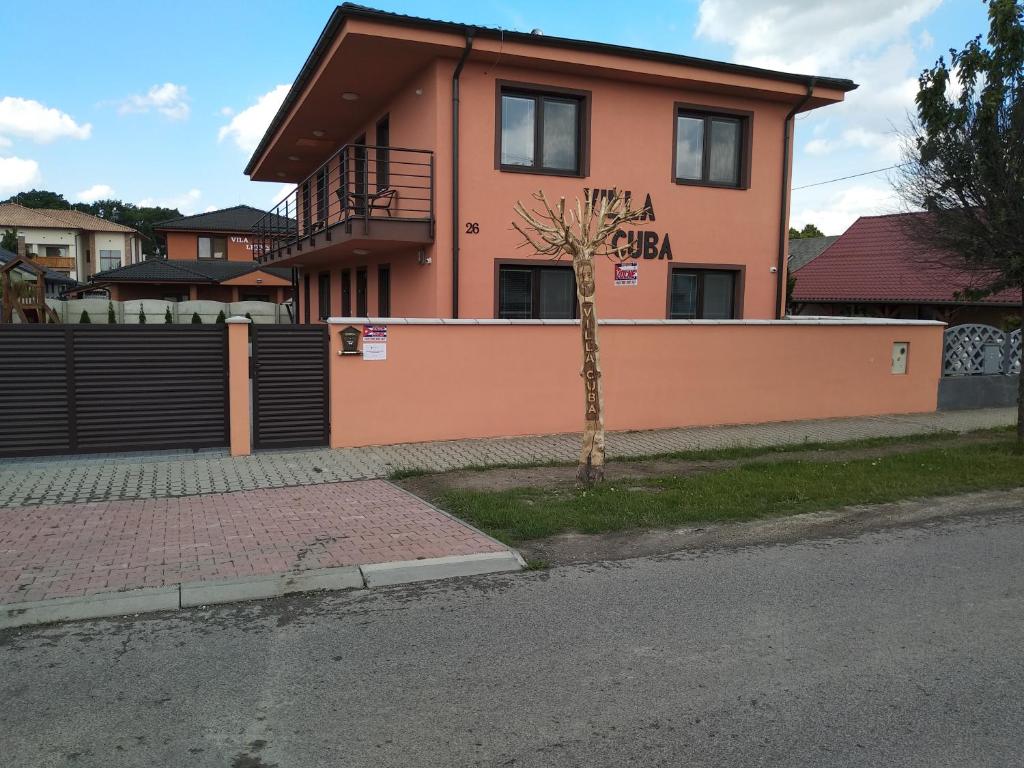 a small tree in front of a house at Villa Cuba in Veľký Meder