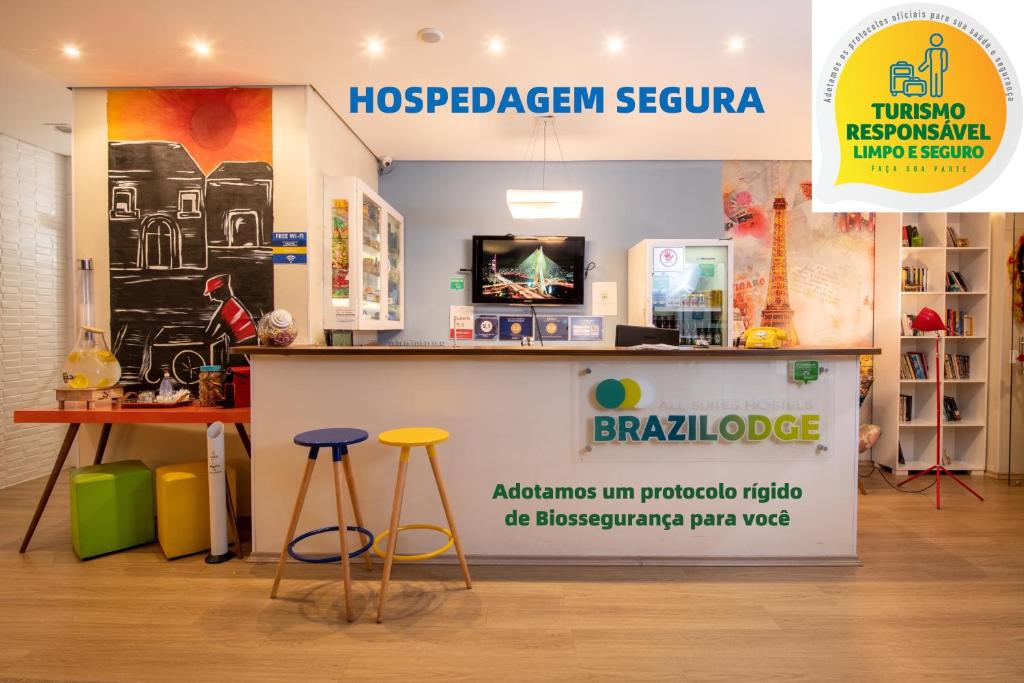 Brazilodge All Suites Hostel في ساو باولو: متجر به كونتر وكراسي في غرفة