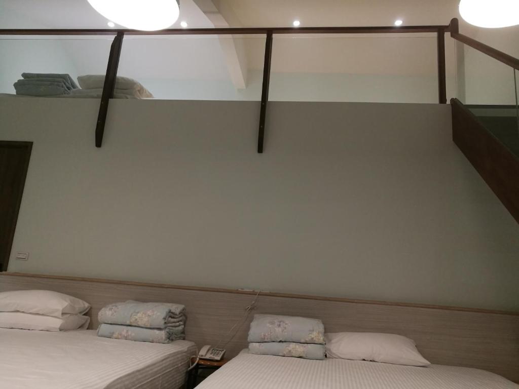 Postel nebo postele na pokoji v ubytování 名竹旅社 Minzu Hotel