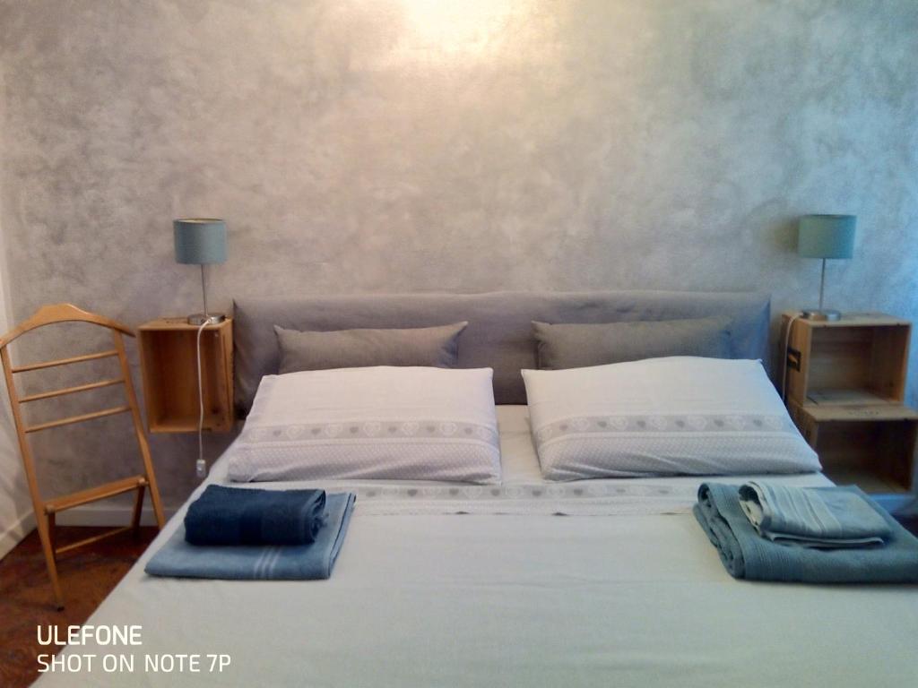 a bed with two pillows on it in a room at A Casa di Irene in Como