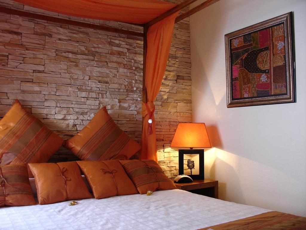 a bedroom with a bed and a brick wall at La Villa Marbella - Old Town in Marbella