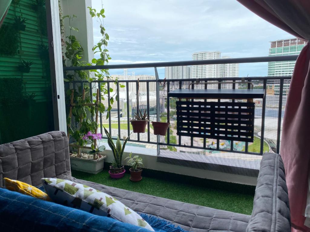 a balcony with a couch and a view of the city at TR Penang House for Large Family Getaways in Bayan Lepas