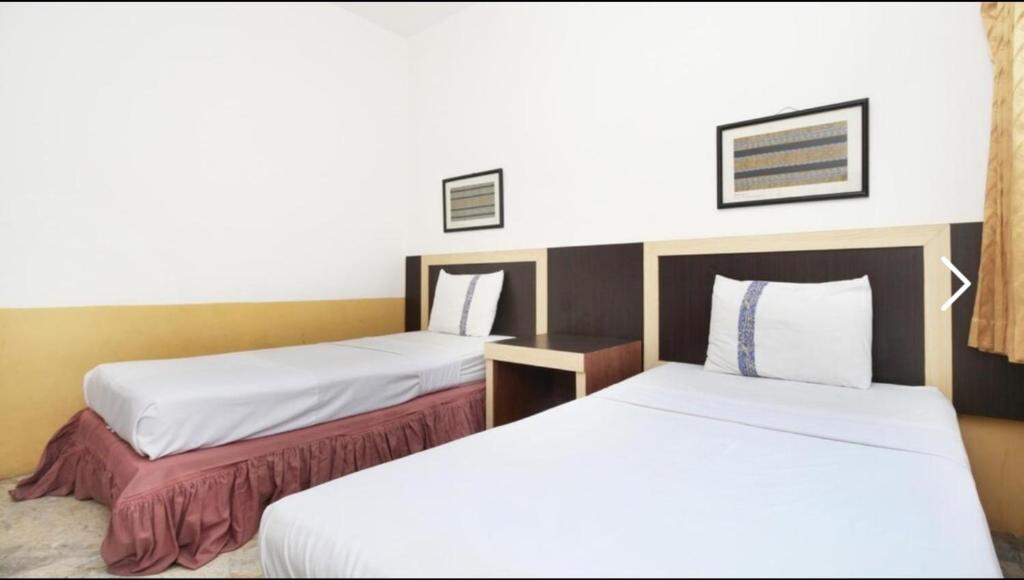 Postel nebo postele na pokoji v ubytování Hotel Syariah Cordova