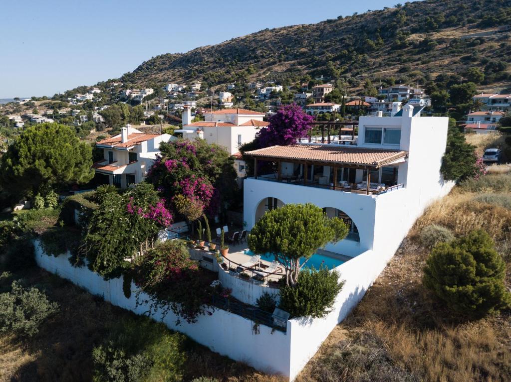 an aerial view of a white house with trees at Villa Noria in Aghia Marina