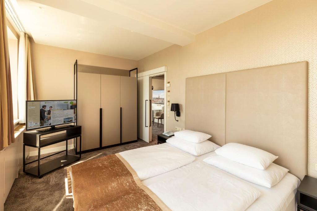 Voodi või voodid majutusasutuse Hotel Am Parkring toas