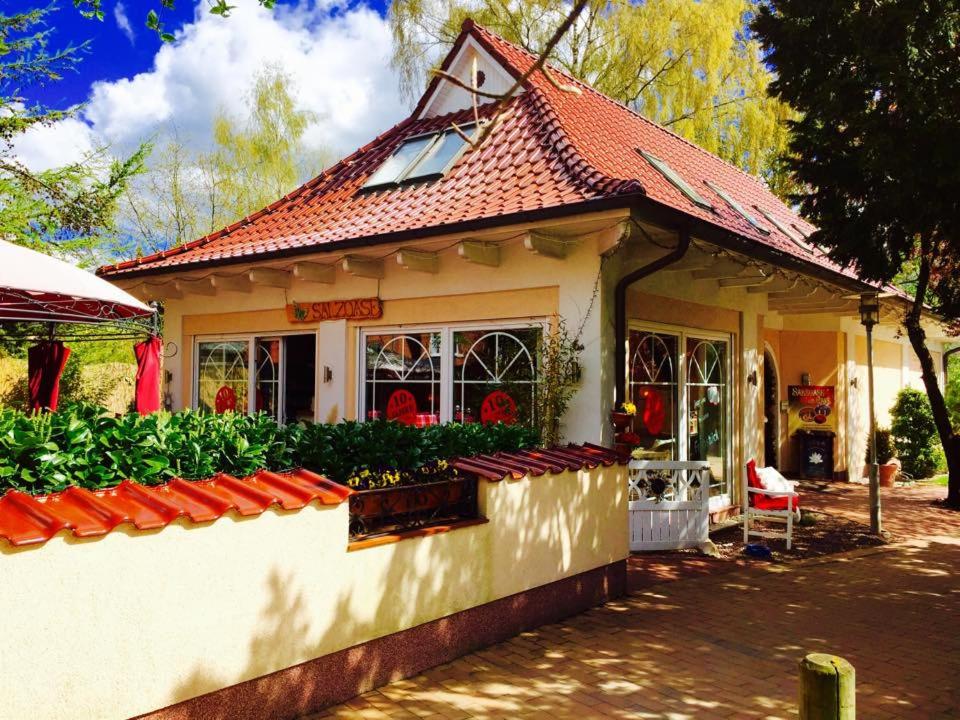 a small house with a garden in front of it at Salzoasen Apartment in Bad Schwartau