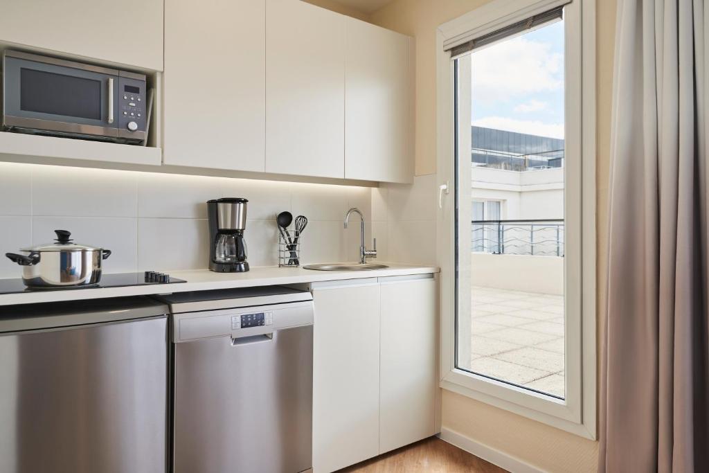 Kuchyň nebo kuchyňský kout v ubytování Aparthotel Adagio Porte de Versailles