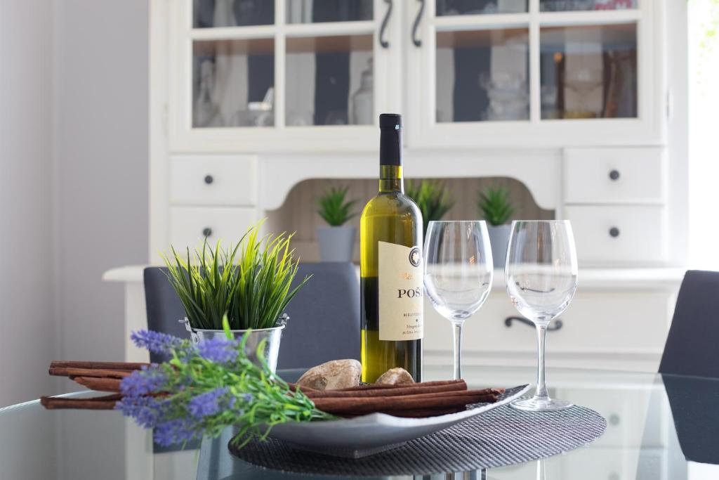 uma garrafa de vinho sentada numa mesa com dois copos em Relax Apartment em Split