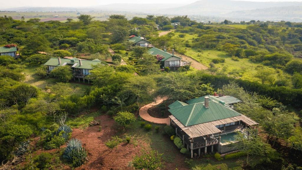 an aerial view of a house in a field at Ngorongoro Oldeani Mountain Lodge in Oldeani