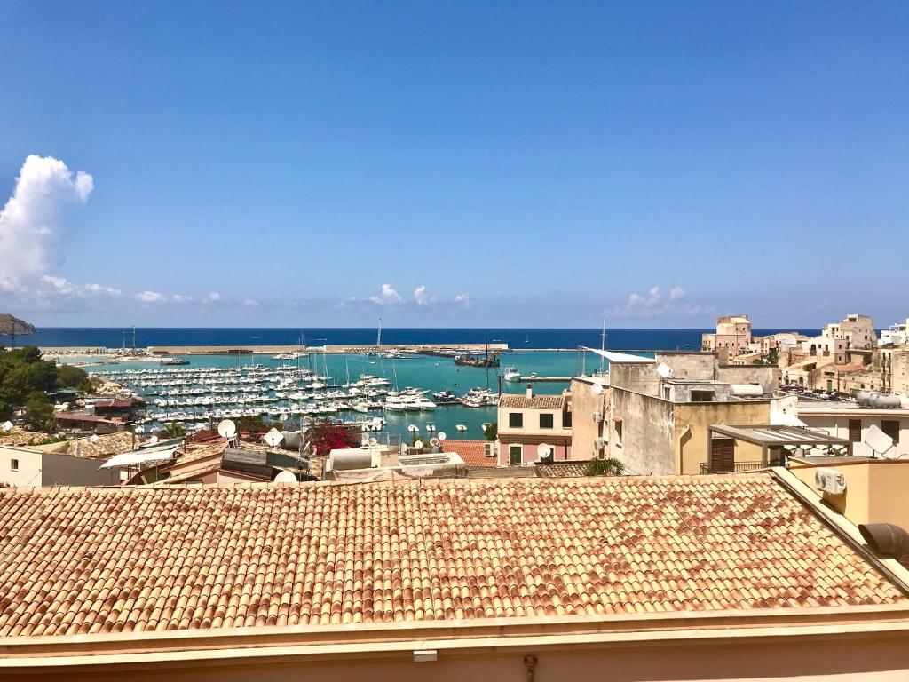 a view of a city with boats in the water at Castellammare Smart Rooms in Castellammare del Golfo