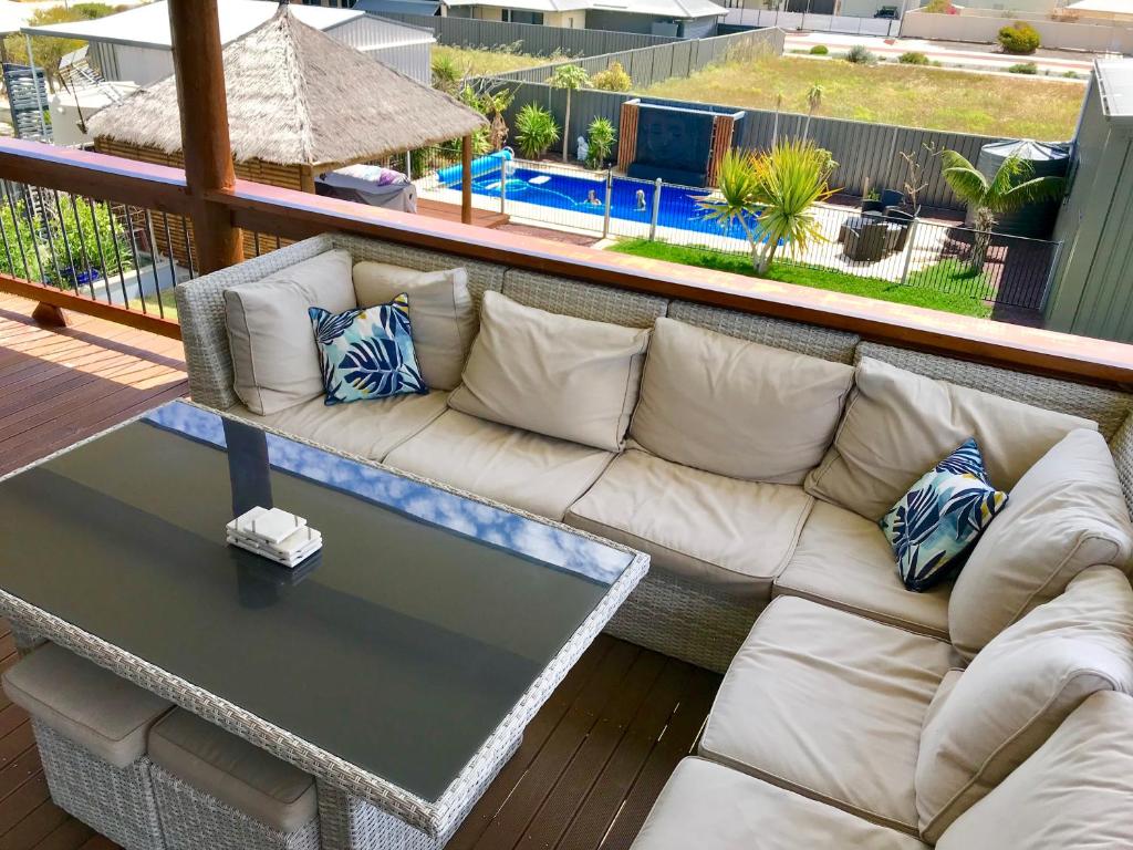 a white couch sitting on a deck with a table at Coastal Paradise Jurien Bay in Jurien Bay