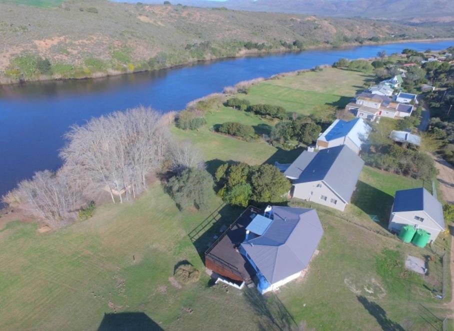 an aerial view of a house next to a river at Staples House - Living The Breede in Malgas