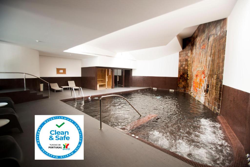 - une grande piscine d'eau au milieu d'une pièce dans l'établissement Hotel Rali Viana, à Viana do Castelo