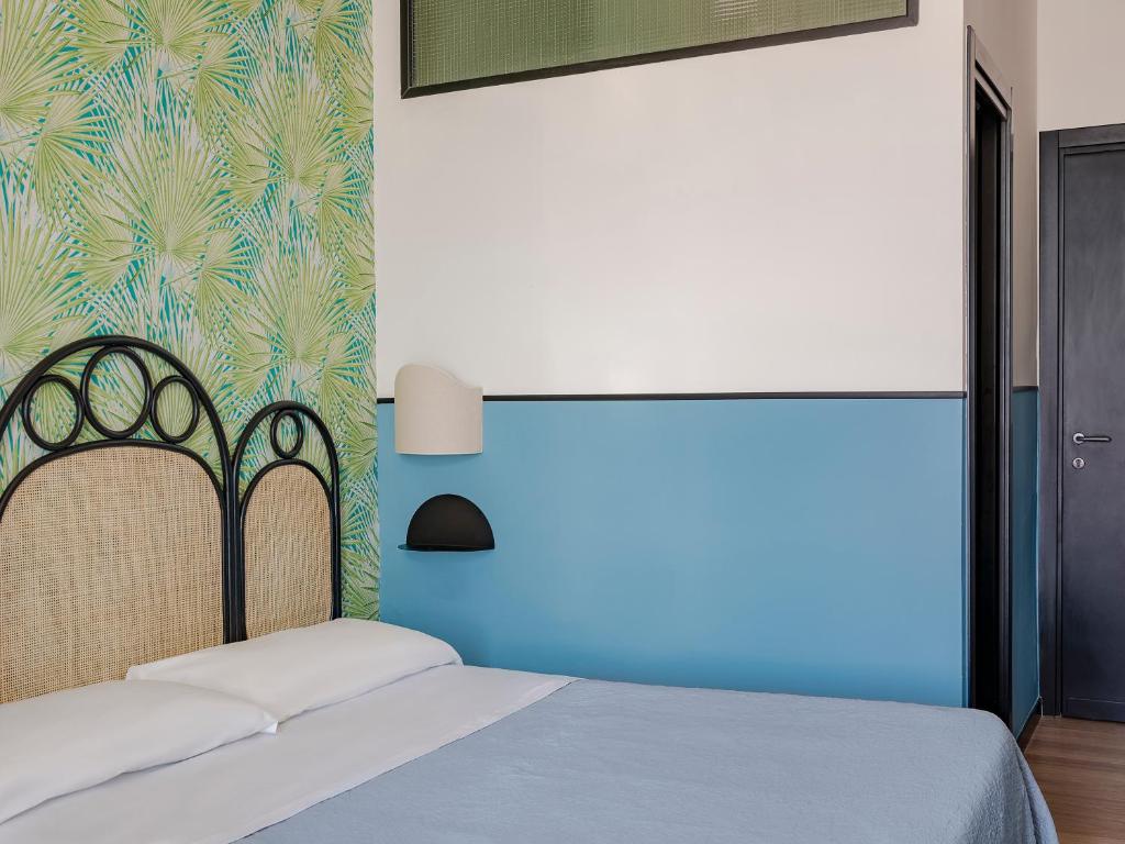 Postel nebo postele na pokoji v ubytování Hotel Riviera