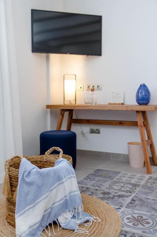 a room with a table and a blue suitcase at La Serena Boutique Hotel & Wellness - Altea in Altea