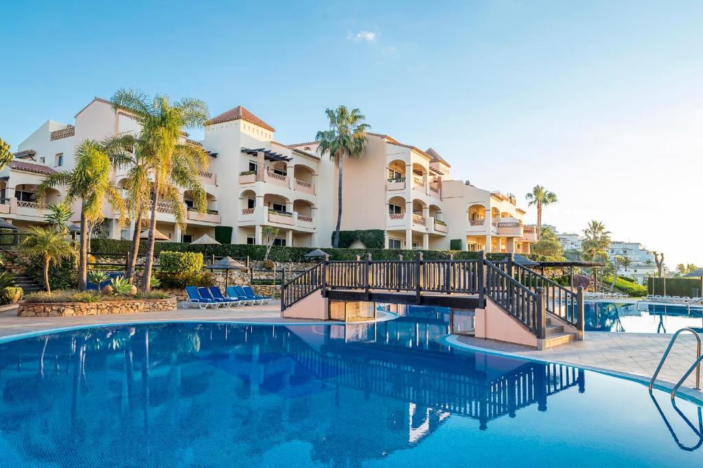 a swimming pool in front of a resort at Wyndham Residences Costa del Sol in Fuengirola