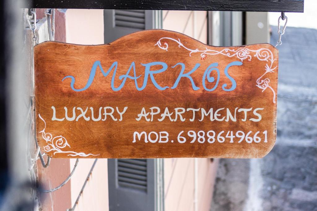 a sign for a marigoldsury apartments at MARKOS LUXURY APARTMENTS in Koroni