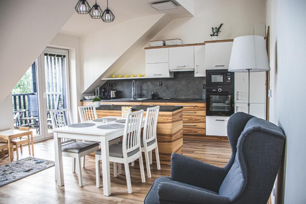 a kitchen and dining room with a table and chairs at Apartmán Na Vršku in Dolní Morava